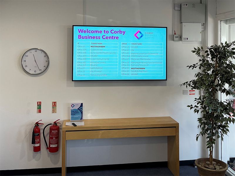 A sign on the wall says welcome to carby business centre