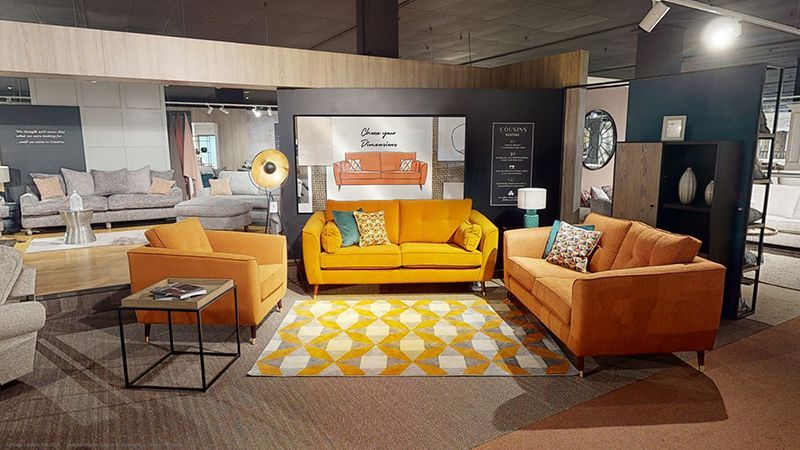 A living room filled with furniture and a rug in a furniture store.