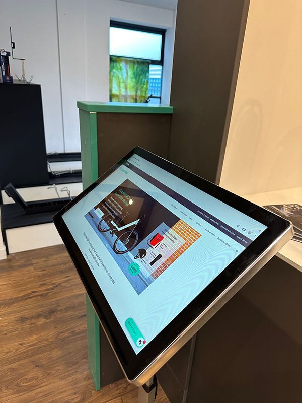 A tablet with a bicycle on the screen is sitting on a table.