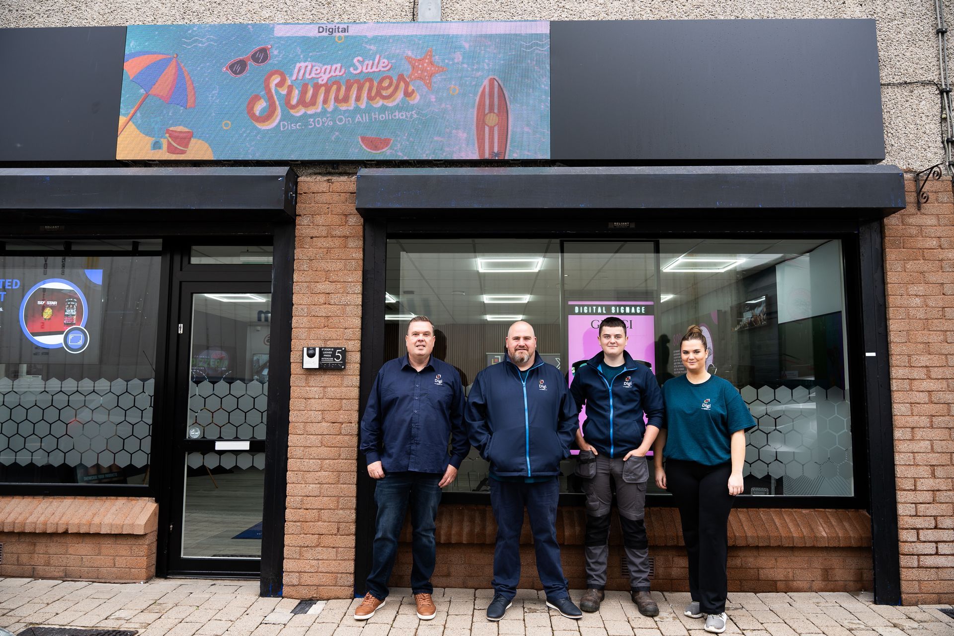 A group of people are standing in front of a building.