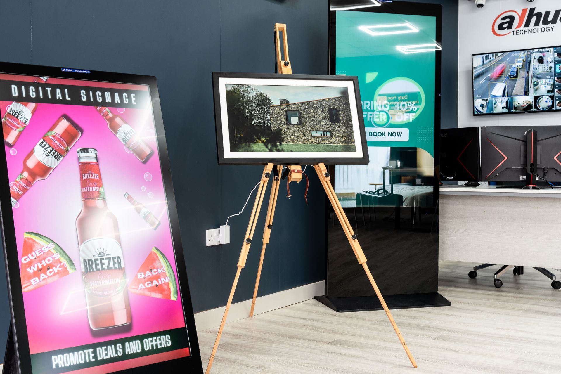 A sign that says digital signage is on an easel in a room.