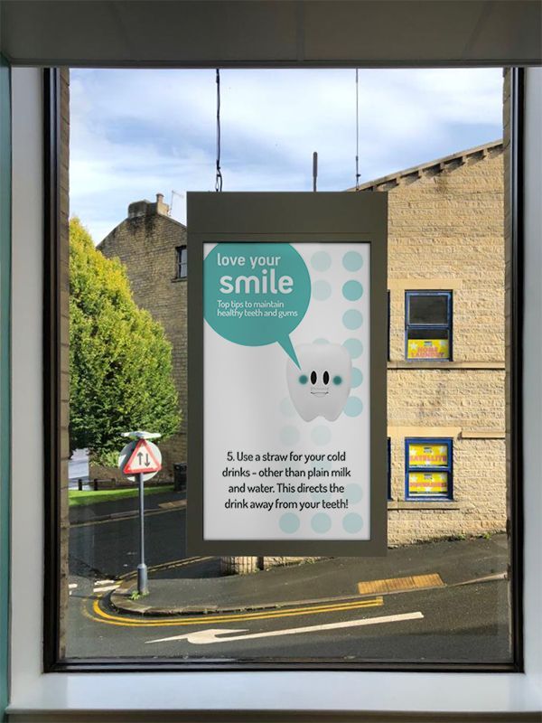 A window with a sign that says love your smile