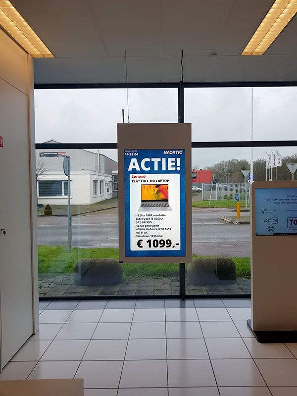 A sign hanging from the ceiling that says actie