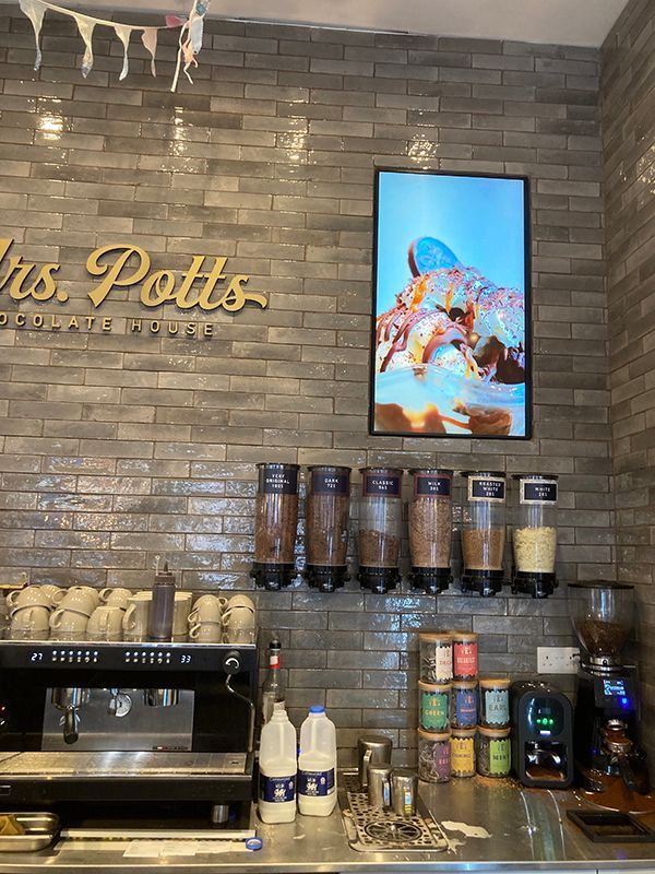 A kitchen with a sign that says ' mrs. potts ' on it