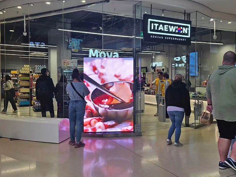 A group of people are standing in front of a store.