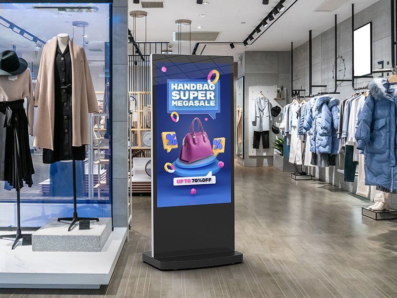 A digital sign is displayed in a clothing store.