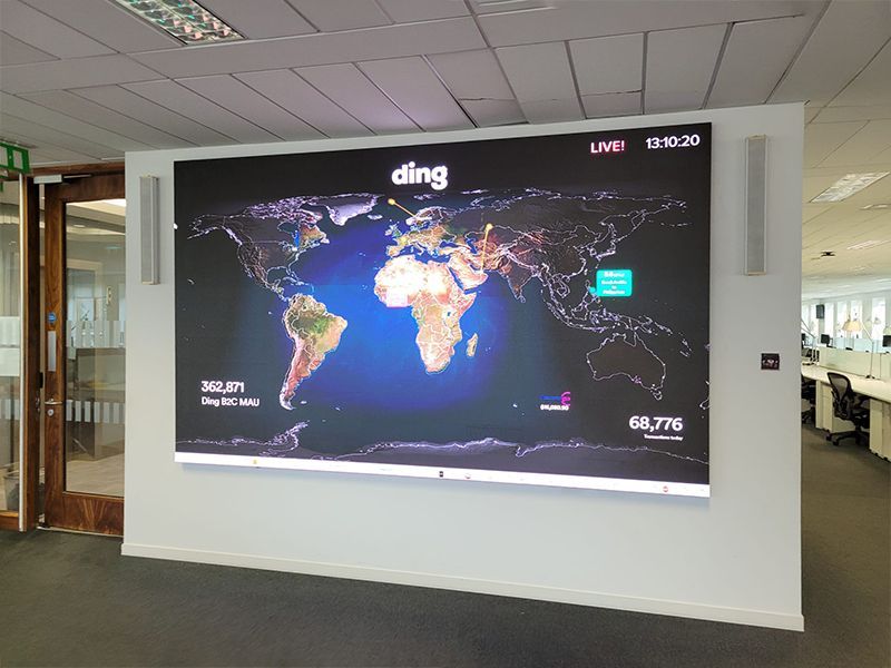 A large screen with a map of the world on it