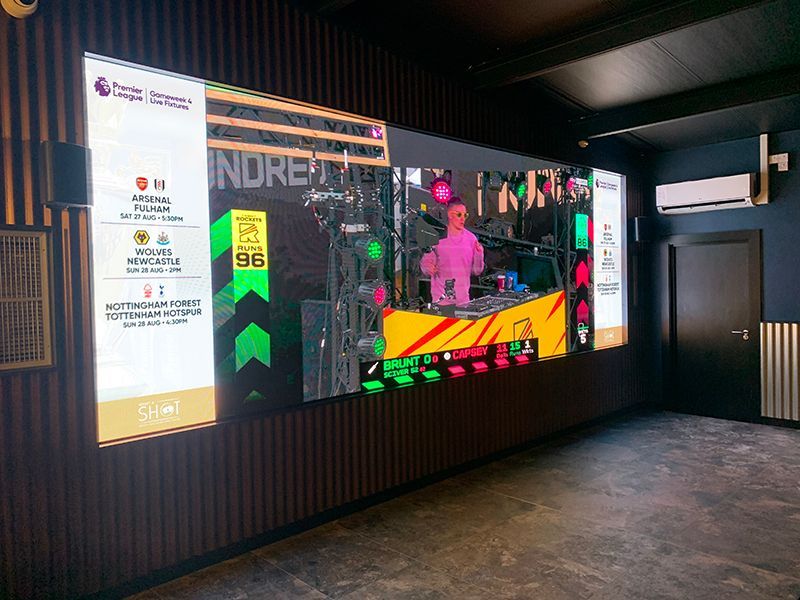 A large screen is hanging on a wall in a room.