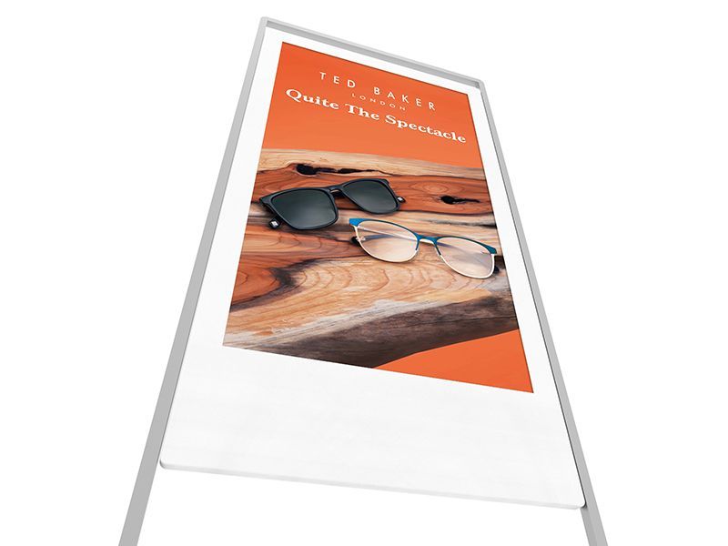 A sign with a picture of sunglasses on a wooden table.