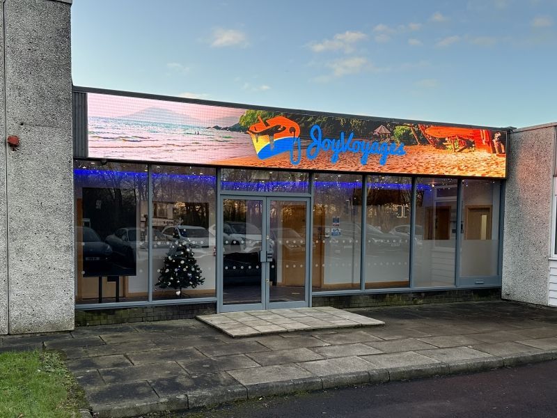 A building with a christmas tree in front of it