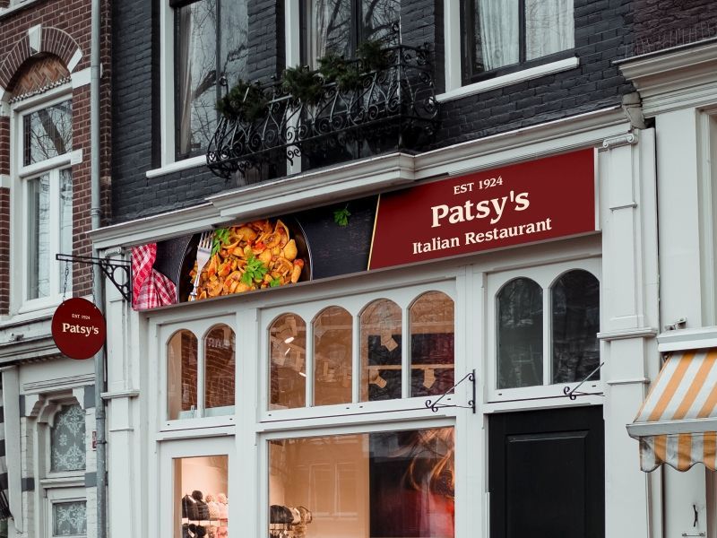 Patsy 's italian restaurant is located on the side of a brick building.