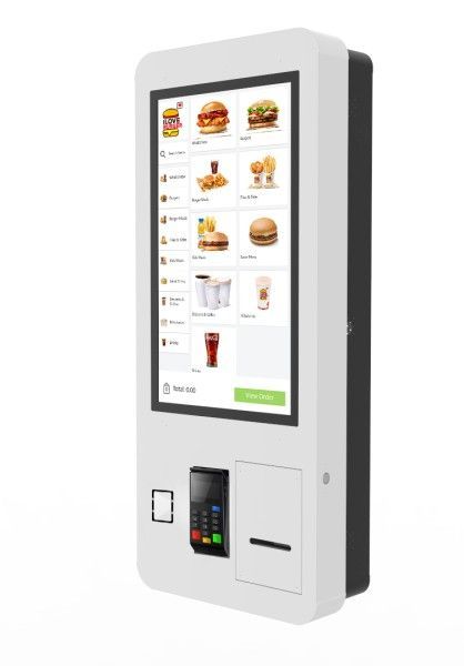 A fast food machine with a large screen and a credit card reader.