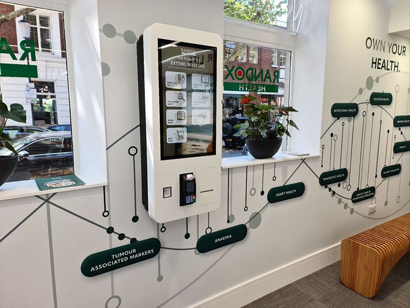 A machine is hanging on a wall in a room next to a window.