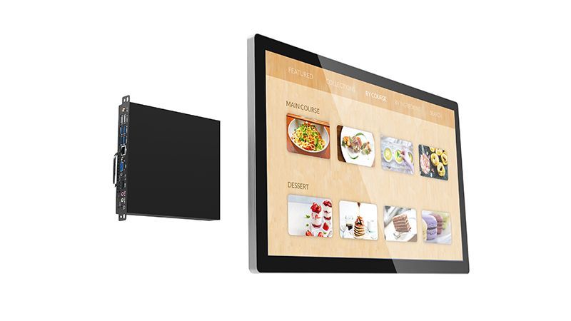 A computer monitor is hanging on a wall next to a smaller monitor.