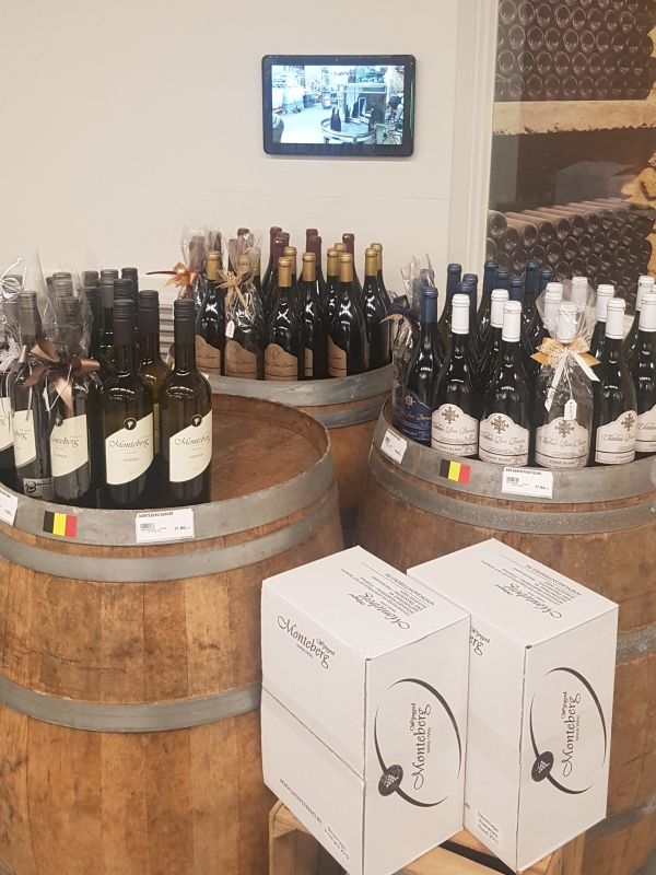 A bunch of bottles of wine are sitting on barrels