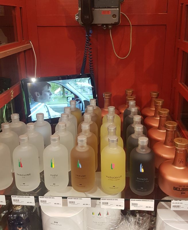 A bunch of bottles are sitting on a shelf in a store.