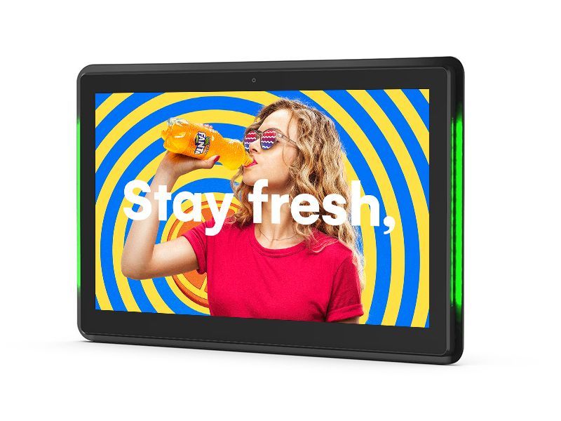 A tablet with a picture of a woman drinking orange juice on it.