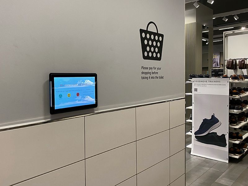 A store with a basket sticker on the wall and a tablet on the wall.