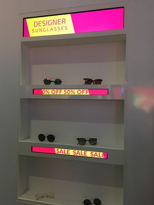 A display of designer sunglasses is on sale