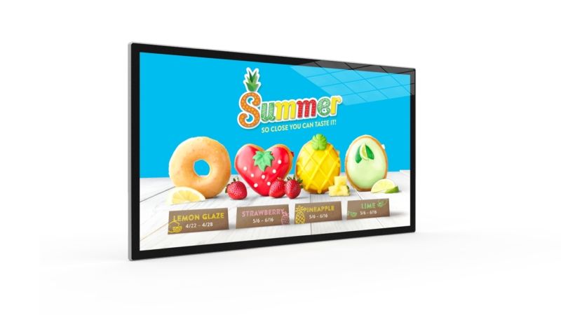 A large flat screen tv with a picture of fruit on it.