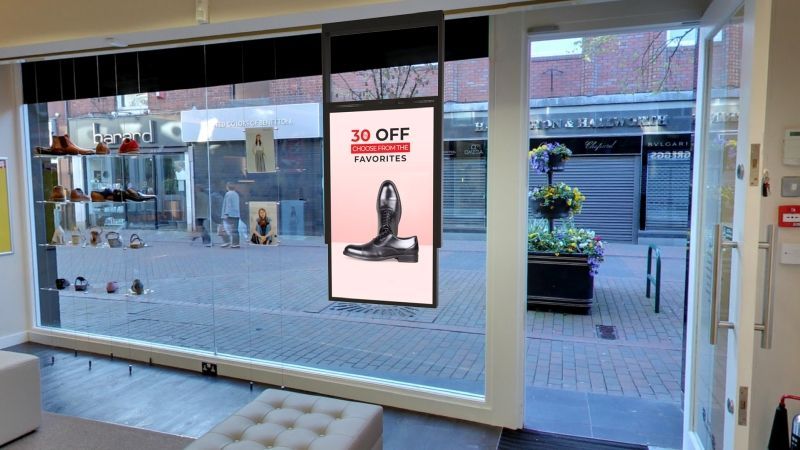 A store front with a sign on the wall that says `` 30 % off ''.