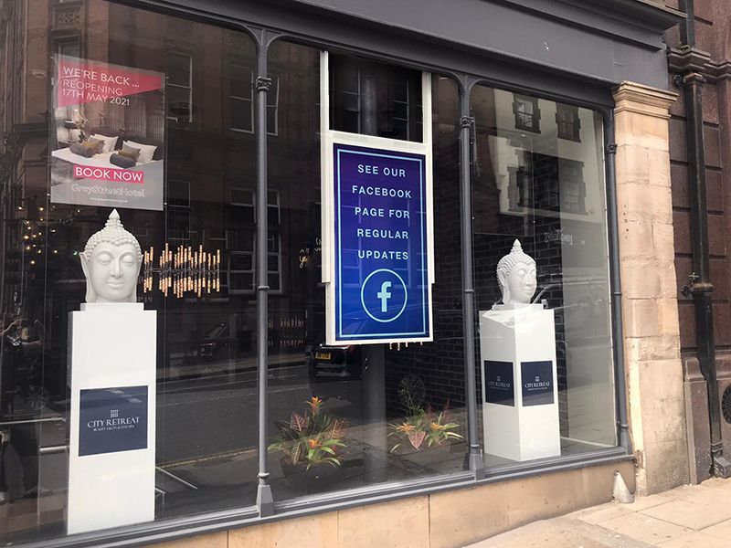 A store front with a sign that says see our facebook