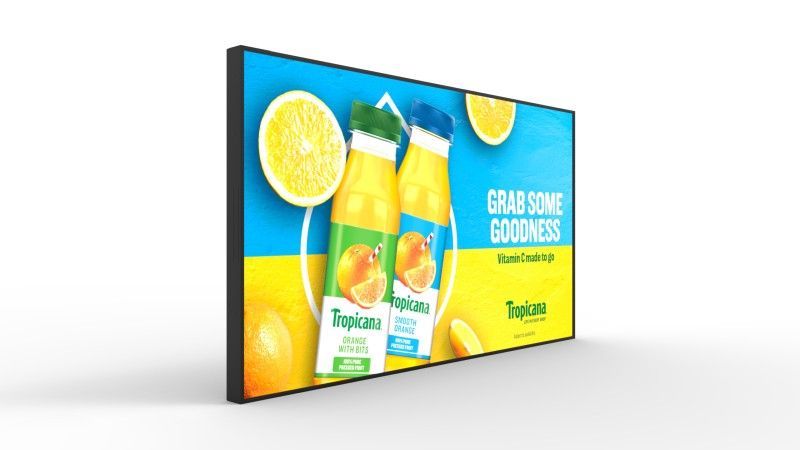 A large flat screen tv with a picture of orange juice on it.