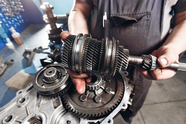 Mechanic working on transmission | Sant Automotive in St. Louis, MO