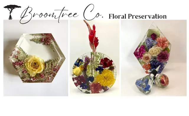 Three resin art pieces containing preserved colorful flowers, labeled Broomtree Co. Floral Preservation.