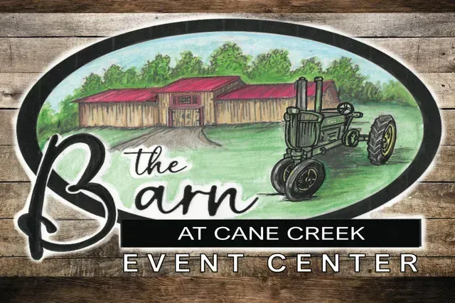 Logo for The Barn at Cane Creek Event Center featuring a painted illustration of a wooden barn and vintage tractor.