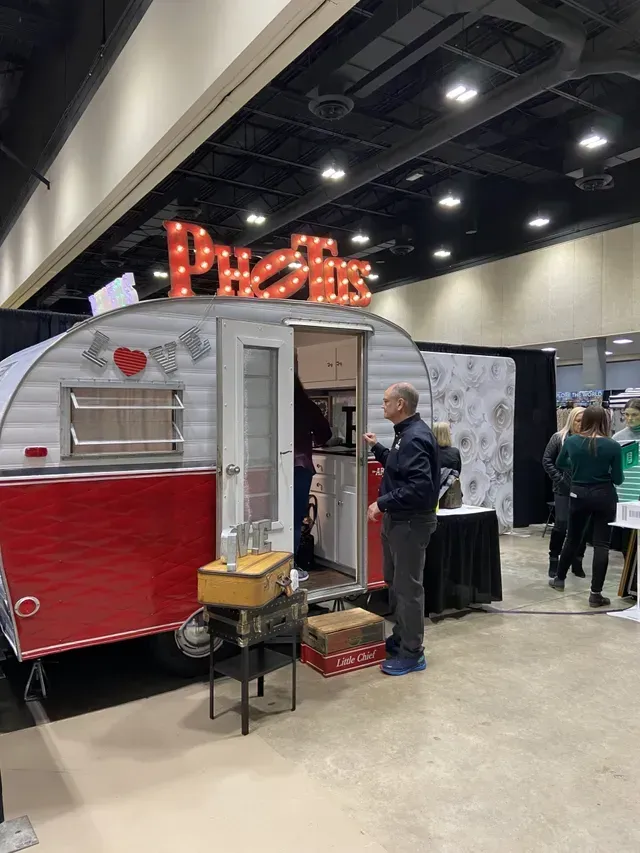 A vintage-style red and white camper photo booth with 