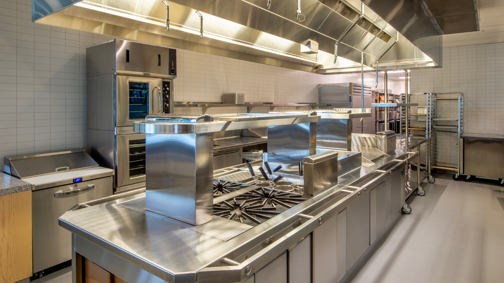 A large kitchen with a lot of stainless steel appliances.