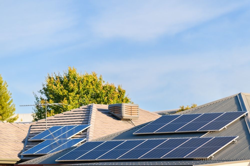 There Are Many Solar Panels On The Roof Of A House — Rapidcool Air Conditioning & Electrical In Fairy Meadow, NSW
