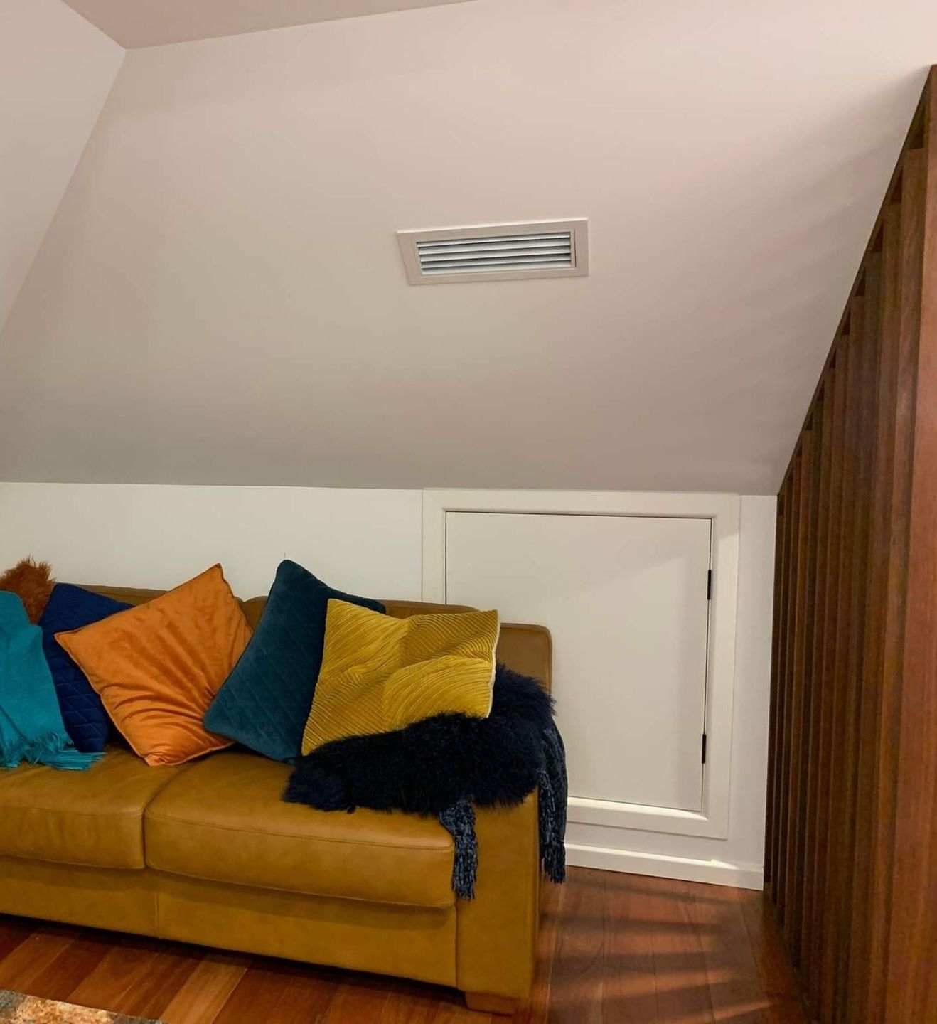 A White Air Conditioner Is Hanging From The Ceiling In A Room — Rapidcool Air Conditioning & Electrical In Dapto, NSW