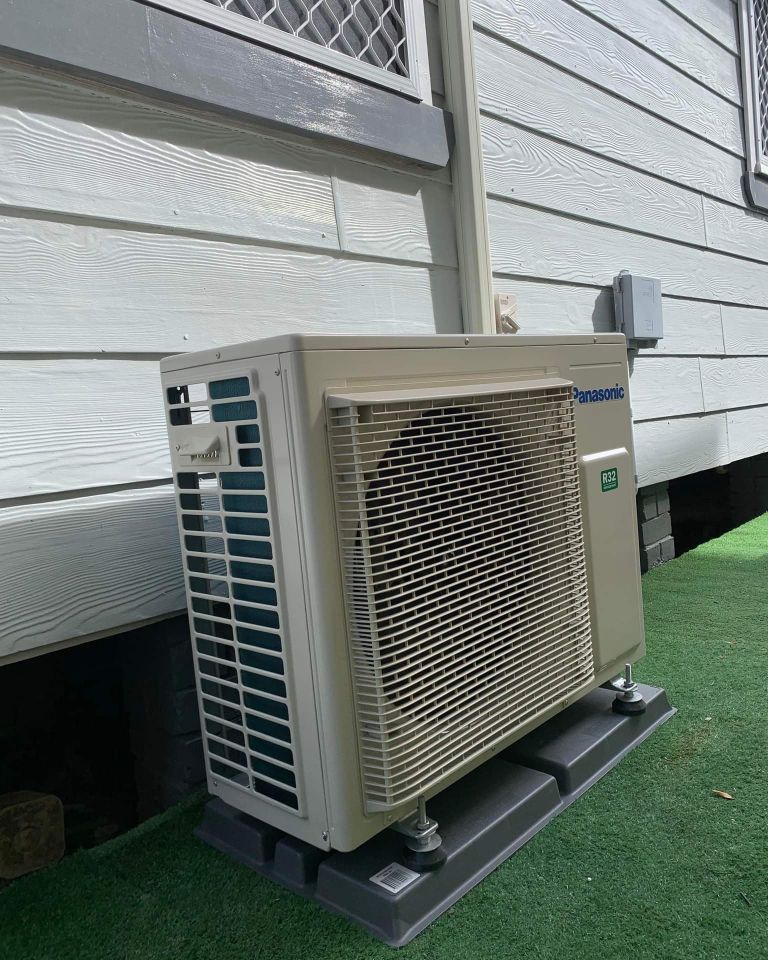 A Large Air Conditioner Is Sitting On The Side Of A House — Rapidcool Air Conditioning & Electrical In Dapto, NSW