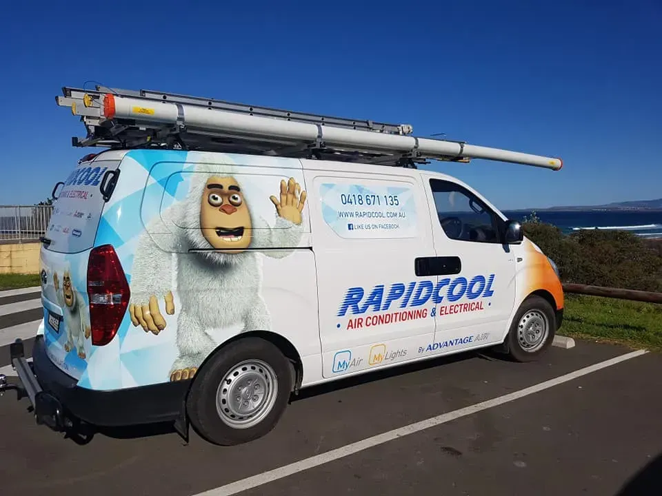 A White Van With A Yeti On The Side Is Parked In A Parking Lot — Rapidcool Air Conditioning & Electrical In Dapto, NSW