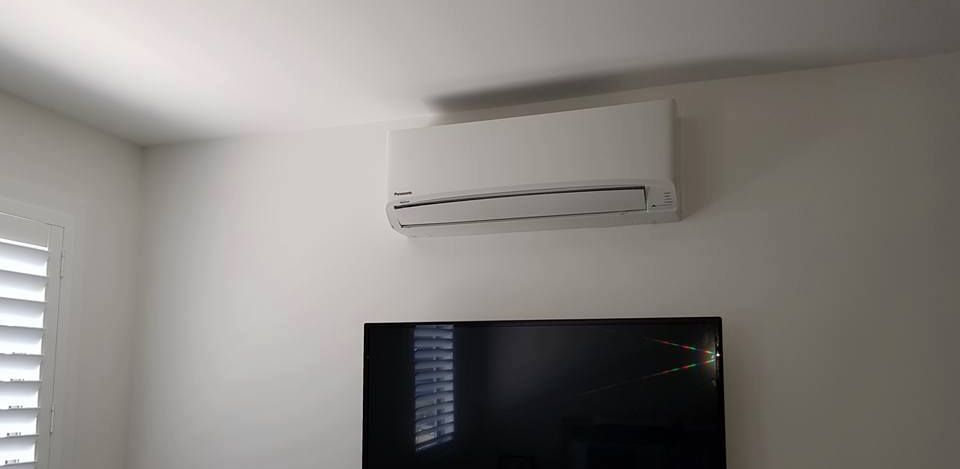 A Room With A Television And A Air Conditioner On The Wall — Rapidcool Air Conditioning & Electrical In Albion Park, NSW