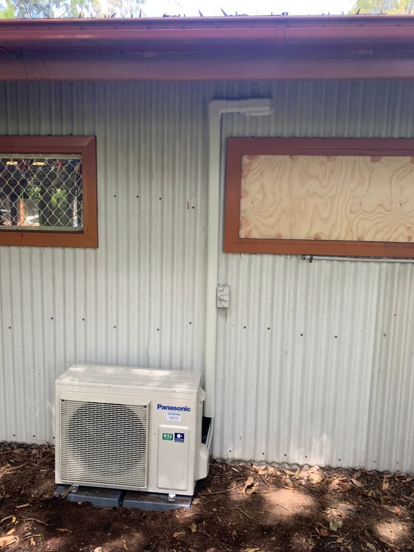 A Corrugated Metal Wall With Two Small Windows — Rapidcool Air Conditioning & Electrical In Wollongong, NSW