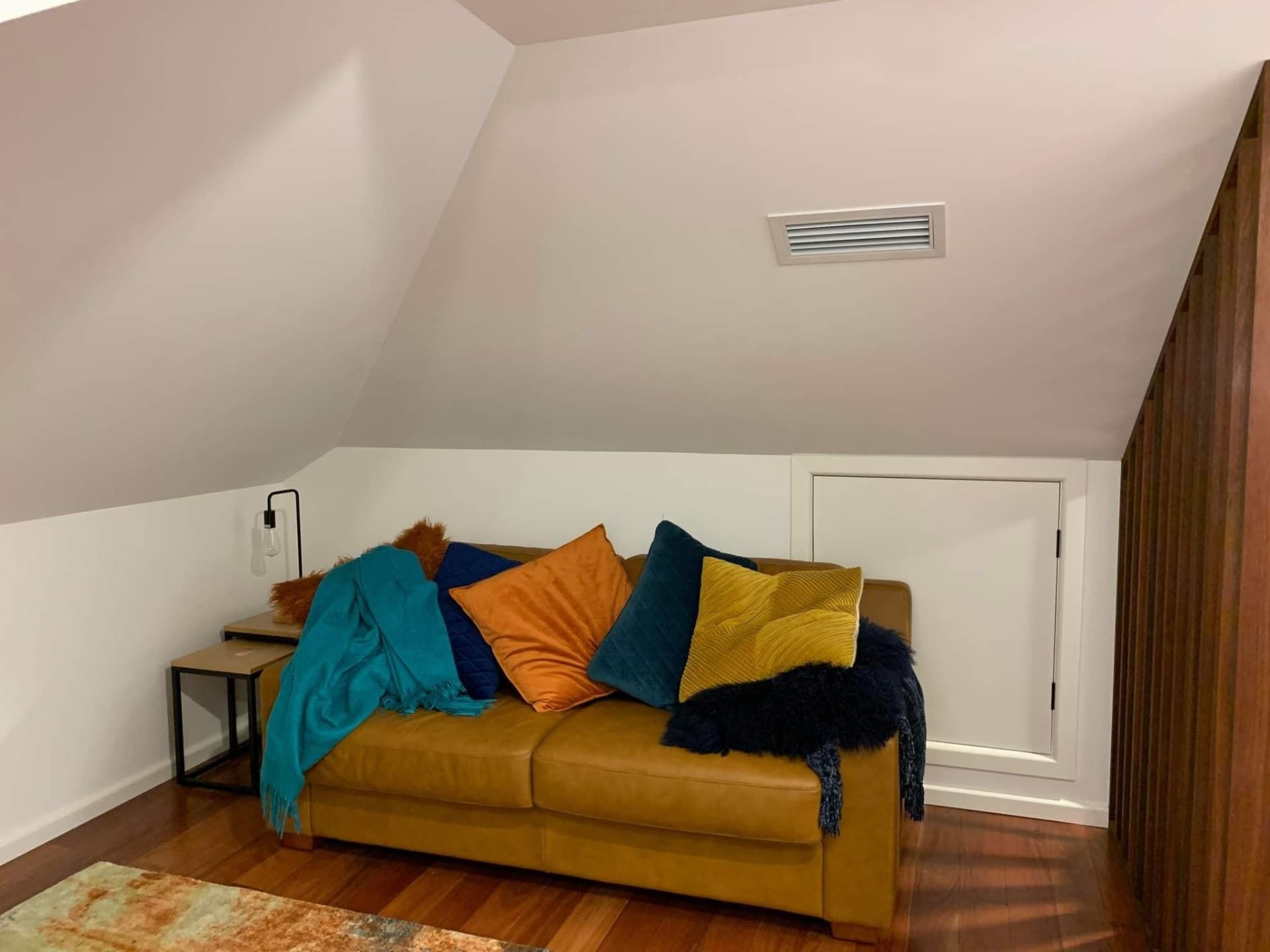 A Cozy Attic Room With a Sloped Ceiling — Rapidcool Air Conditioning & Electrical In Wollongong, NSW
