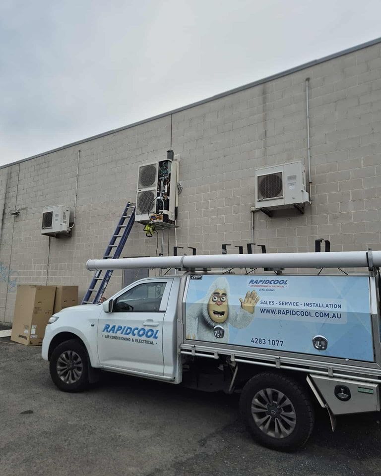 A Utility Vehicle is Parked Beside a Wall — Rapidcool Air Conditioning & Electrical In Wollongong, NSW