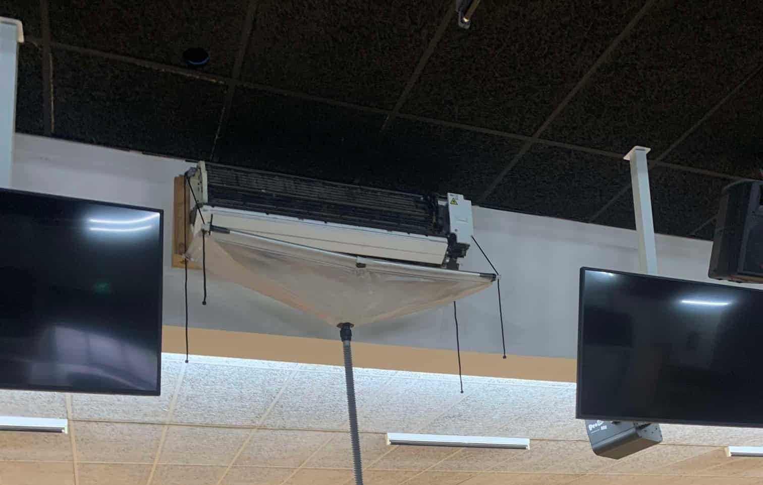 A Bowling Alley With a Ladder Beneath a Ceiling Air Conditioner — Rapidcool Air Conditioning & Electrical In Wollongong, NSW