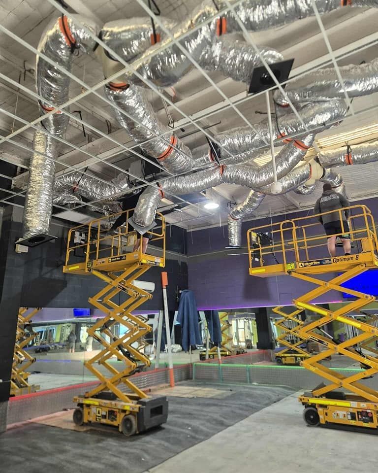 Two Yellow Lifts Beneath Exposed Ductwork — Rapidcool Air Conditioning & Electrical In Wollongong, NSW