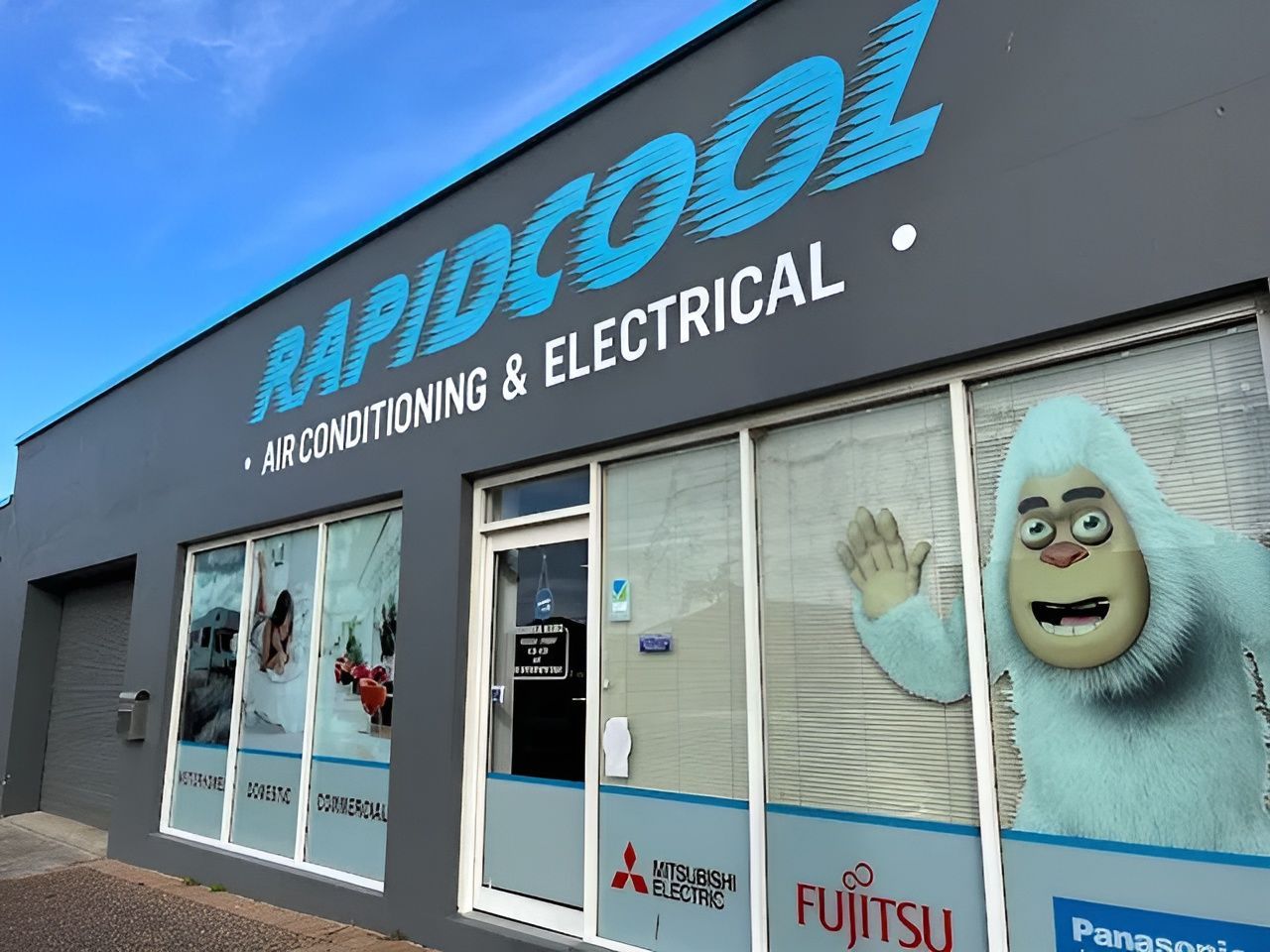 A Building That Says Rapidcool Air Conditioning And Electrical — Rapidcool Air Conditioning & Electrical In Dapto, NSW