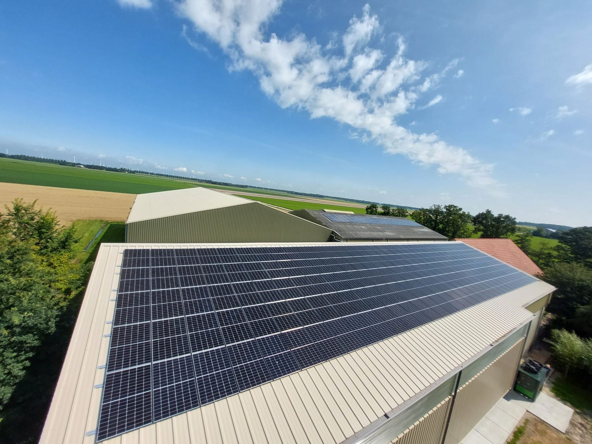 Een groot bedrijfsgebouw met veel zonnepanelen op het dak