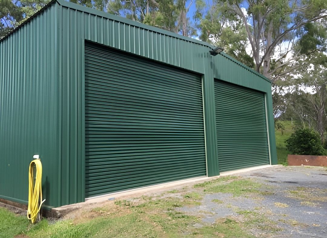 Green Metal Shed With Two Roll-up Doors — All Things Industrial in Mackay, QLD