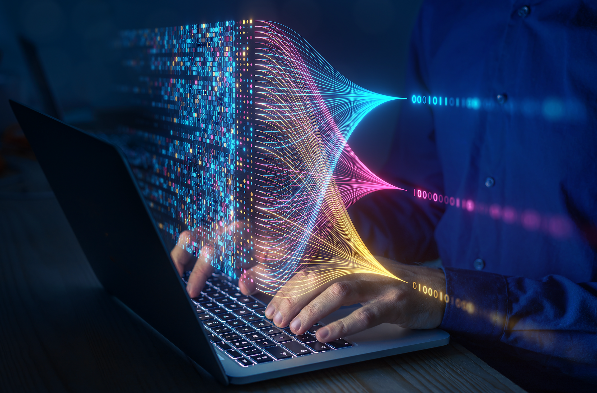 A person is typing on a laptop computer with a futuristic image coming out of it.