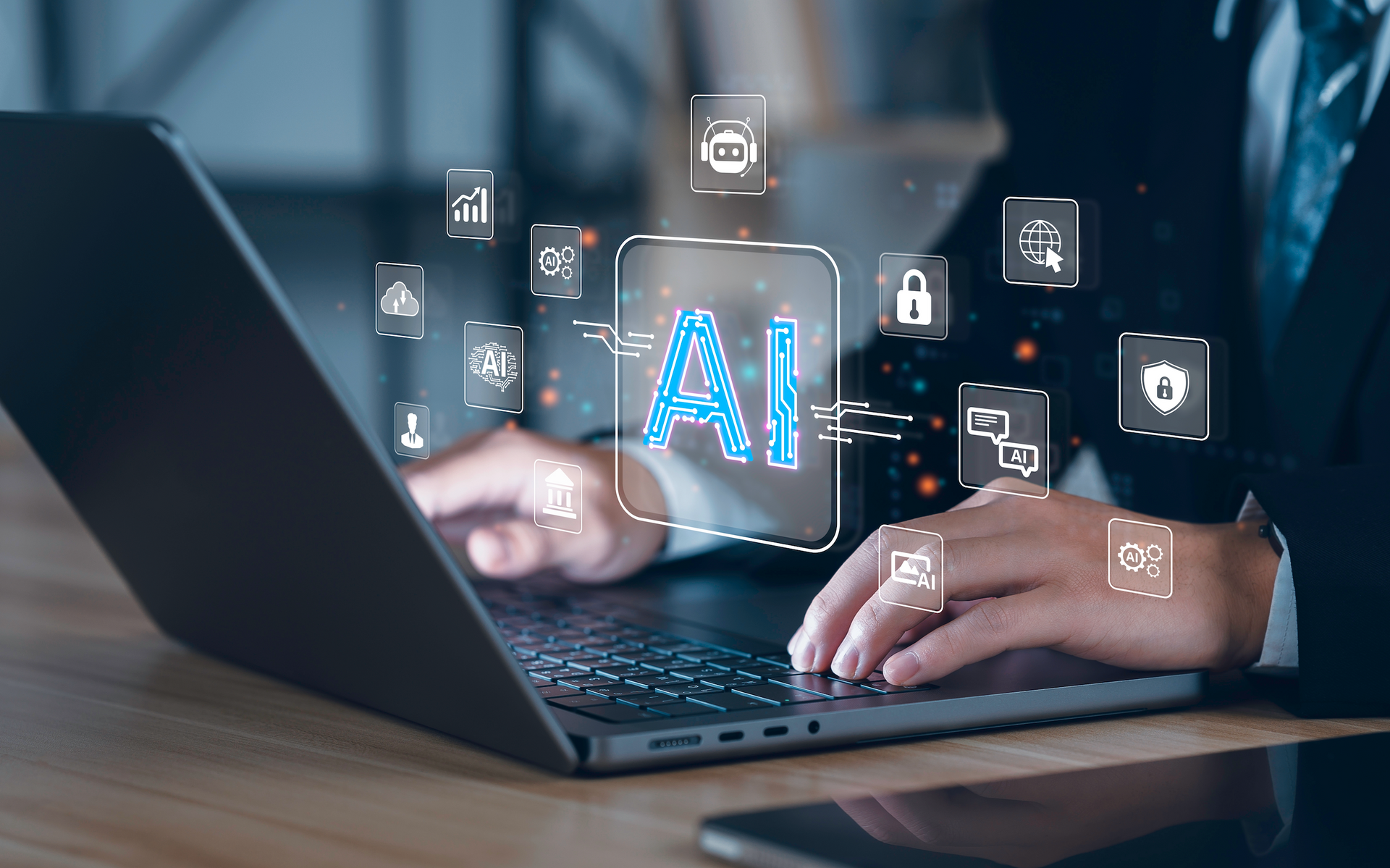 A man in a suit is typing on a laptop computer.