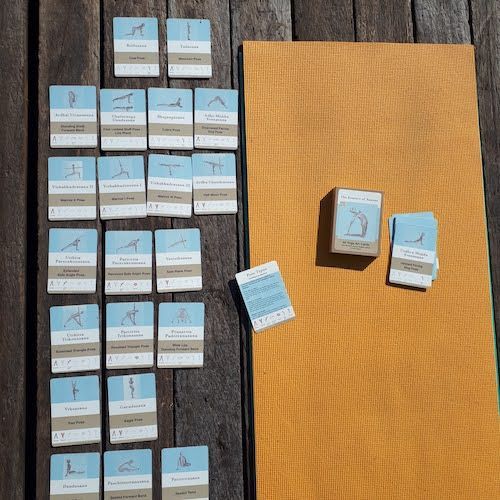 yoga art cards next to mat