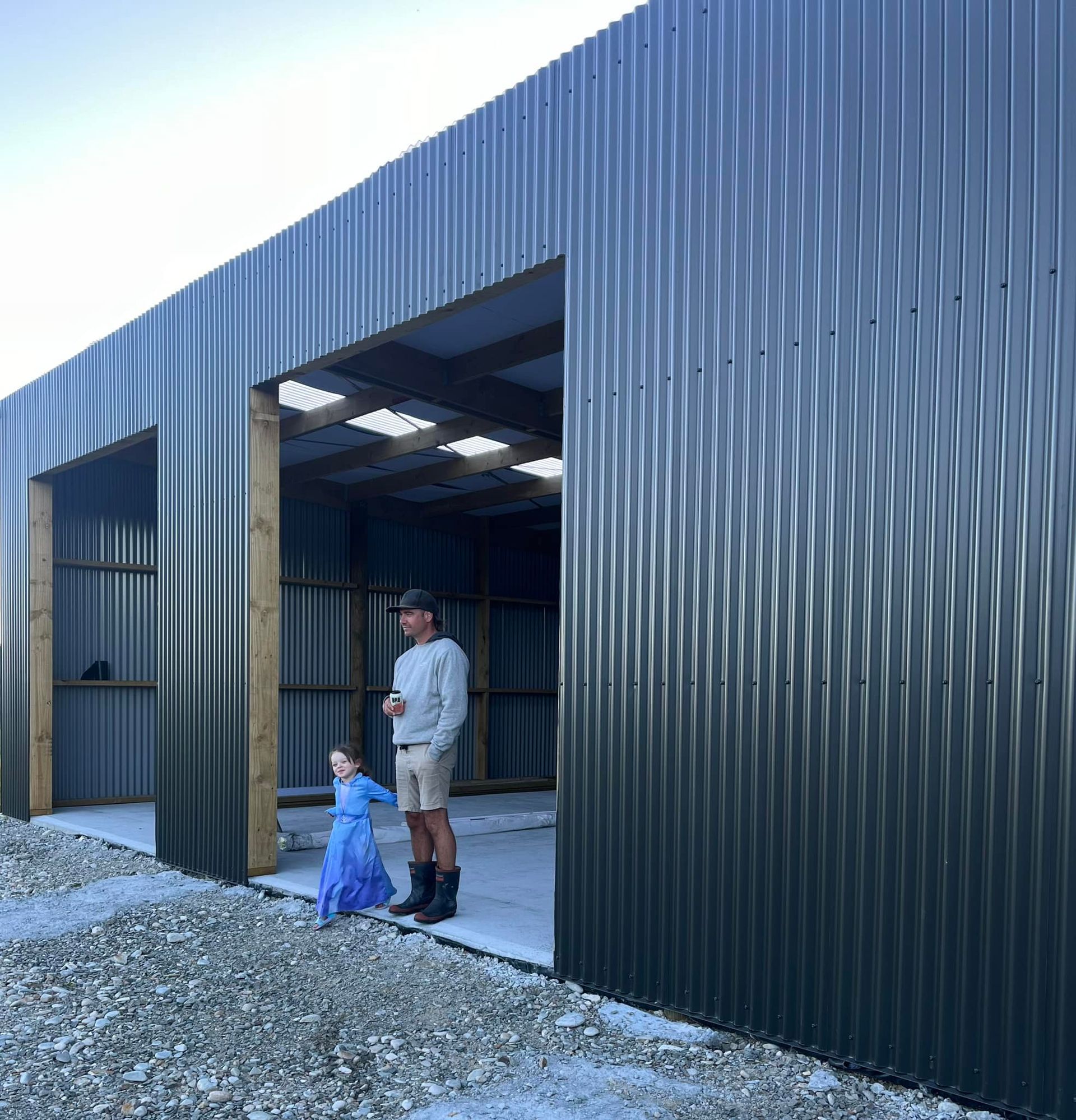 A wooden structure is being built in the middle of a field.