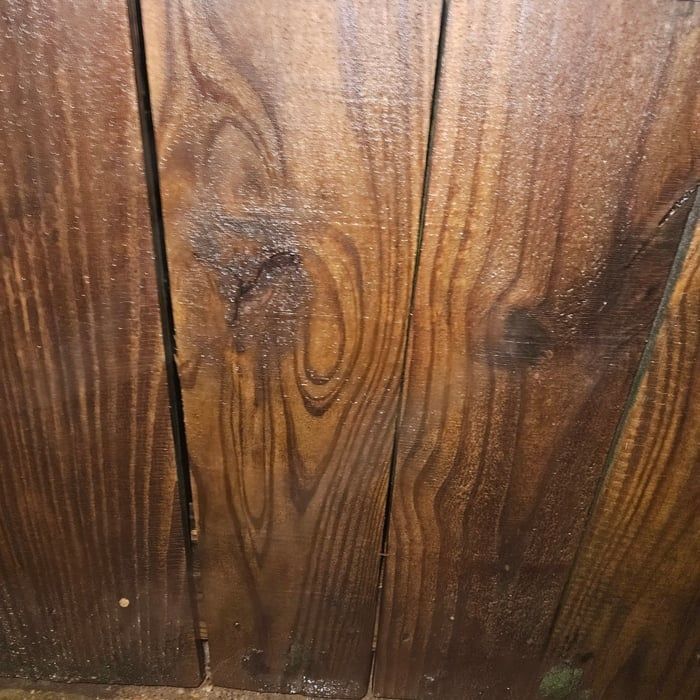 Close-up view of wooden planks with visible wood grain in shades of brown and tan.